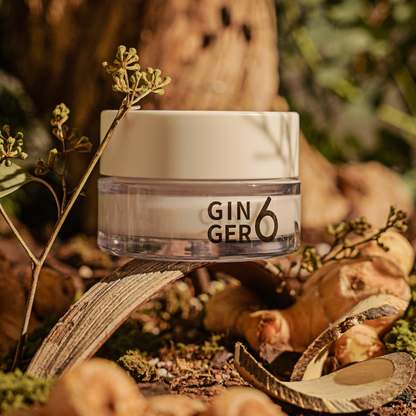 Ginger6 Energizing PEPTI Night Cream elegantly displayed on a wooden branch in a natural forest setting