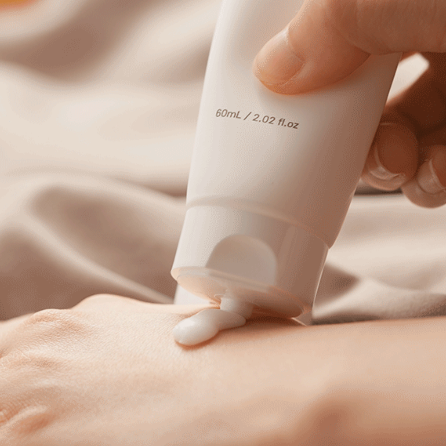 Applying Ginger6 Hand Cream on the back of a hand, showing its smooth and moisturizing texture