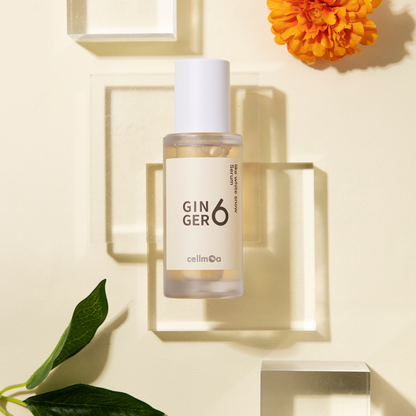 Ginger6 Like White Snow Serum elegantly displayed on clear acrylic blocks with a yellow flower and green leaf